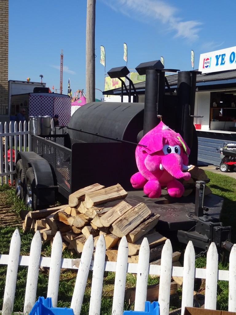 Maybe you had a few beers on the midway, but you really did see this pink elephant guarding the Grange stand's smoker. 